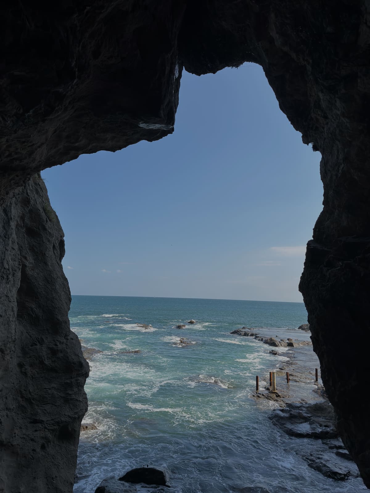 The sea framed by the mouth of a coastal cave in Kanagawa